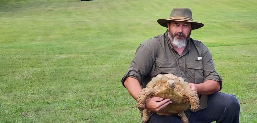 A man holding a tortoise